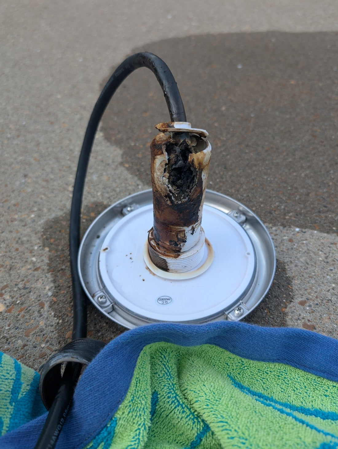 Florida Sun Seeker PoolTone nicheless pool light with a sun-damaged, disintegrated housing