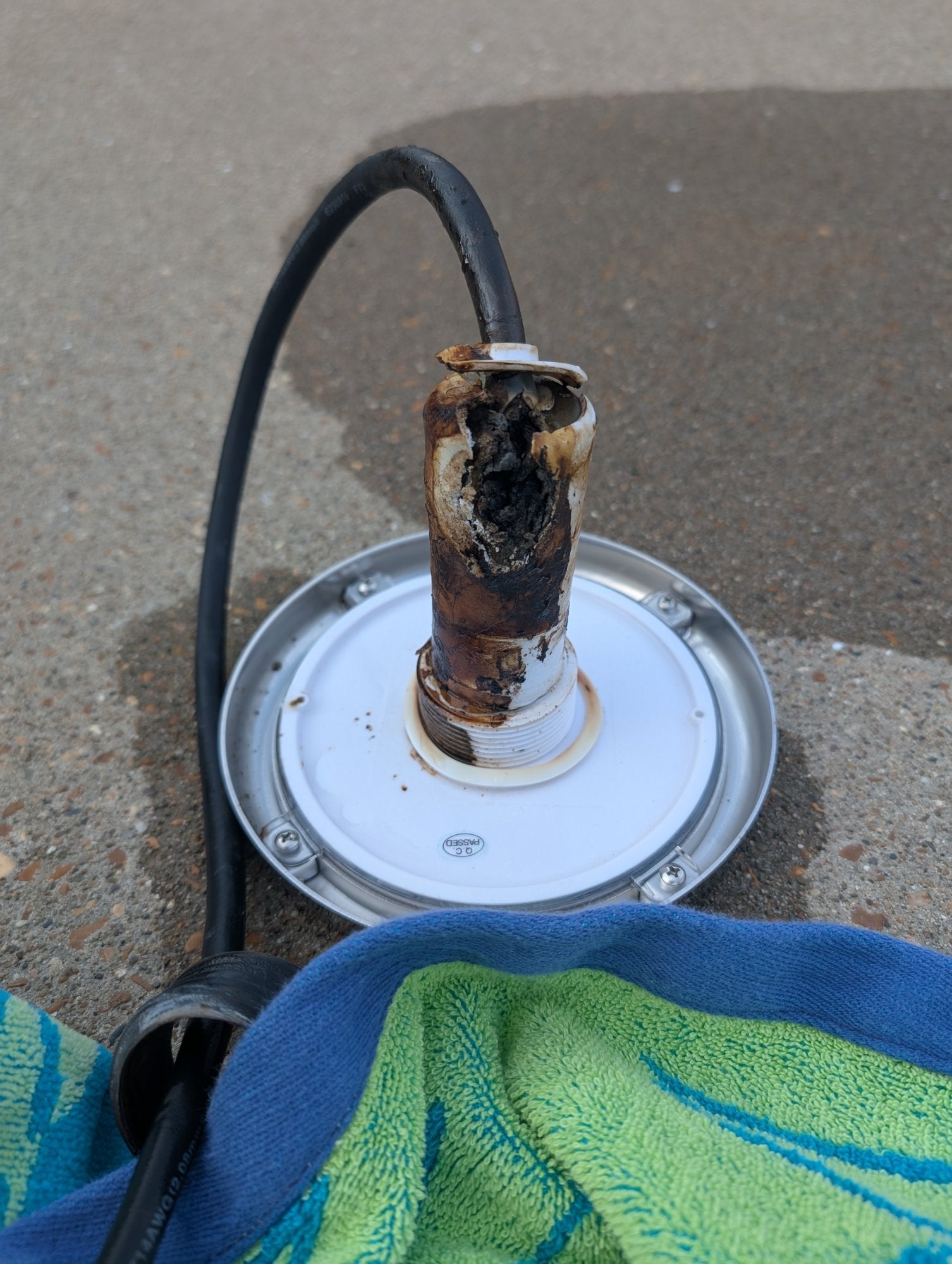 Florida Sun Seeker PoolTone nicheless pool light with a sun-damaged, disintegrated housing