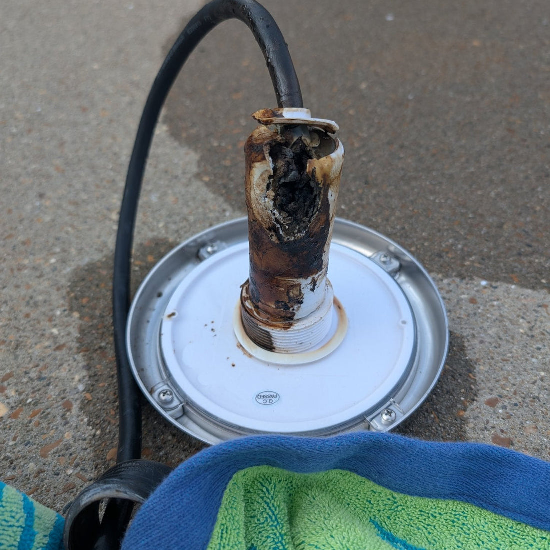 Florida Sun Seeker PoolTone nicheless pool light with a sun-damaged, disintegrated housing
